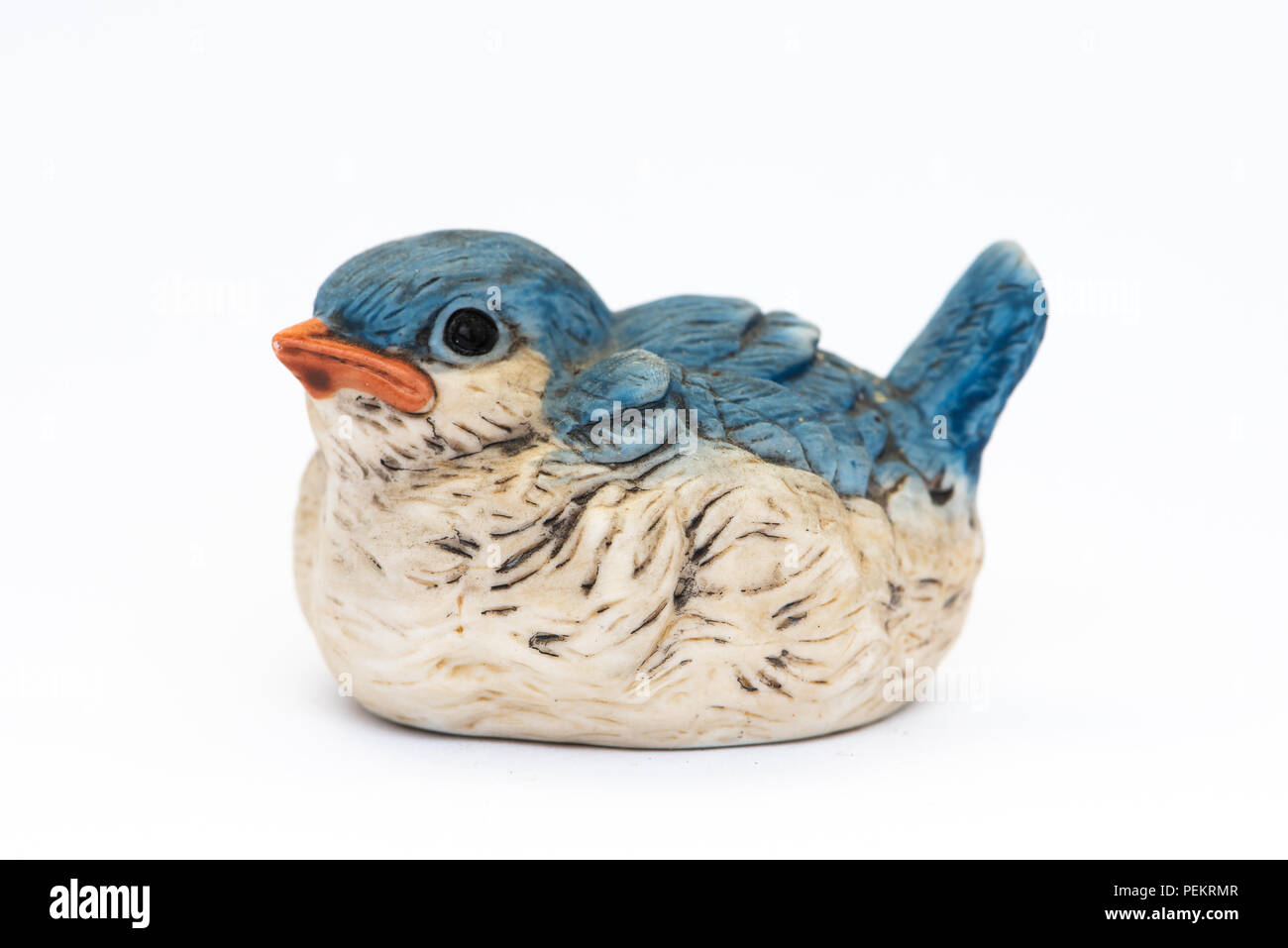 A vintage cute little ceramic blue bird figurine isolated on white. Stock Photo