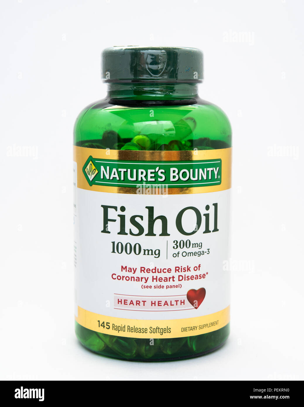 A green bottle of 1000 mg Softgels of fish oil by Nature's Bounty, for promoting heart health. Stock Photo