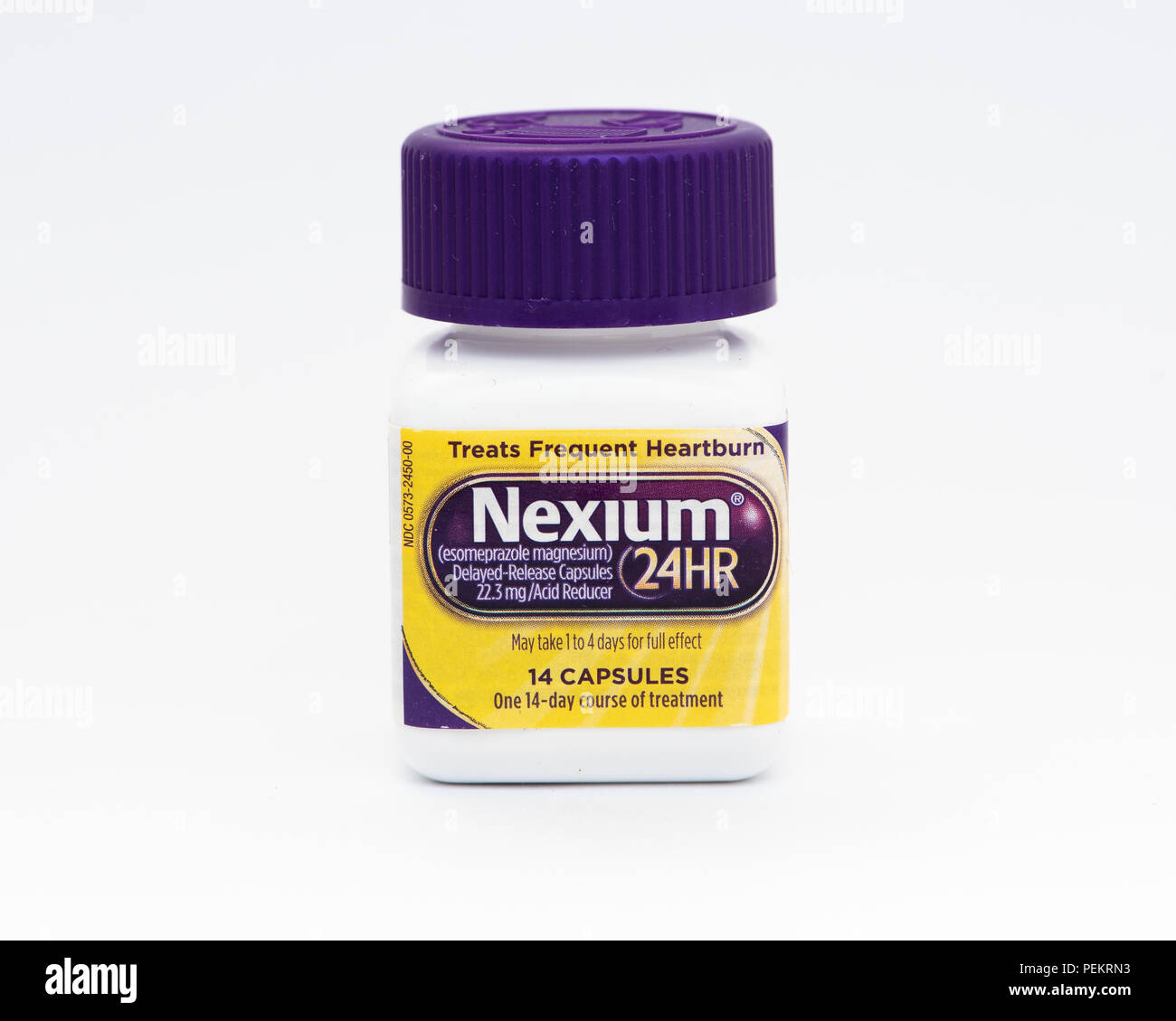 A white plastic bottle containing 14 capsules, 22.3 mg of Nexium for the treatment of frequent heartburn. Stock Photo