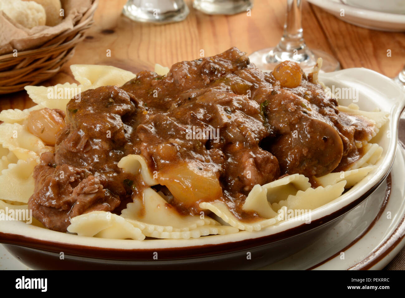 Gourmet Boeuf Bourguignon on a bed of farfalle pasta.  Also known as beef burgundy Stock Photo