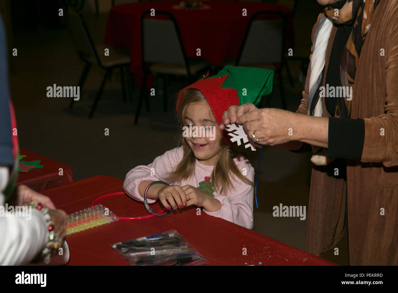 Charlotte Hogan, 5, daughter of Alex Hogan, assistant department head for  operations management, Robert E. Bush Naval Hospital, begins creating  holiday decorations at the hospital's Command Holiday Party at Smith's  Ranch, Dec.