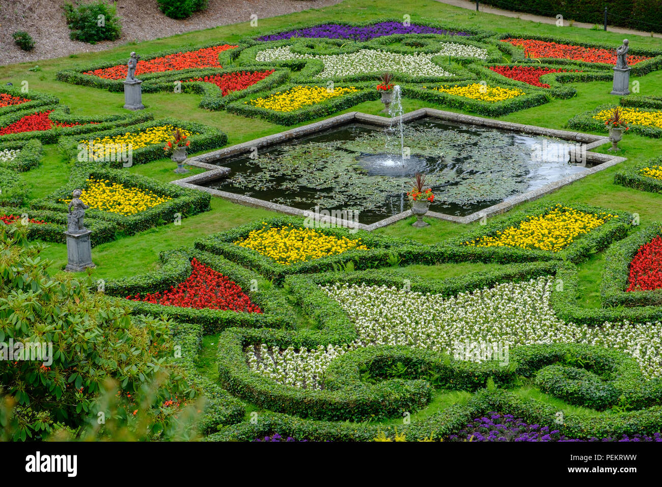 Fountain, pond and beautiful gardens at Lyme Hall stately home in Peak