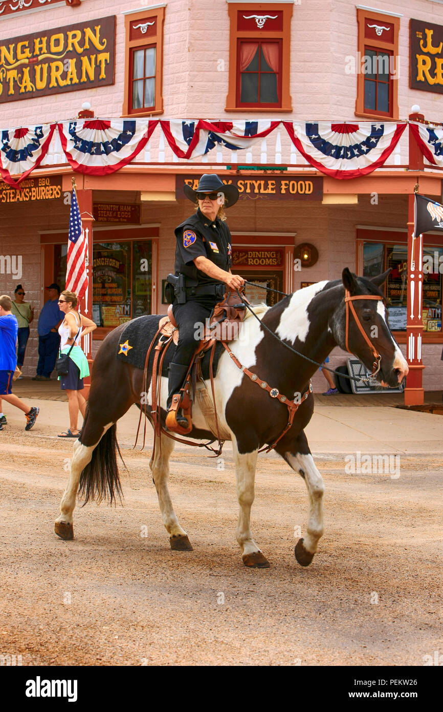 Female Arizona Ranger on horseback rides along E Allen St at the annual Doc Holiday event in Tombstone Stock Photo