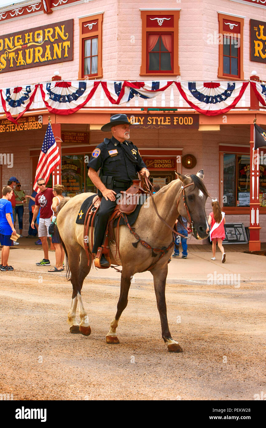 Male Arizona Ranger on horseback rides along E Allen St at the annual Doc Holiday event in