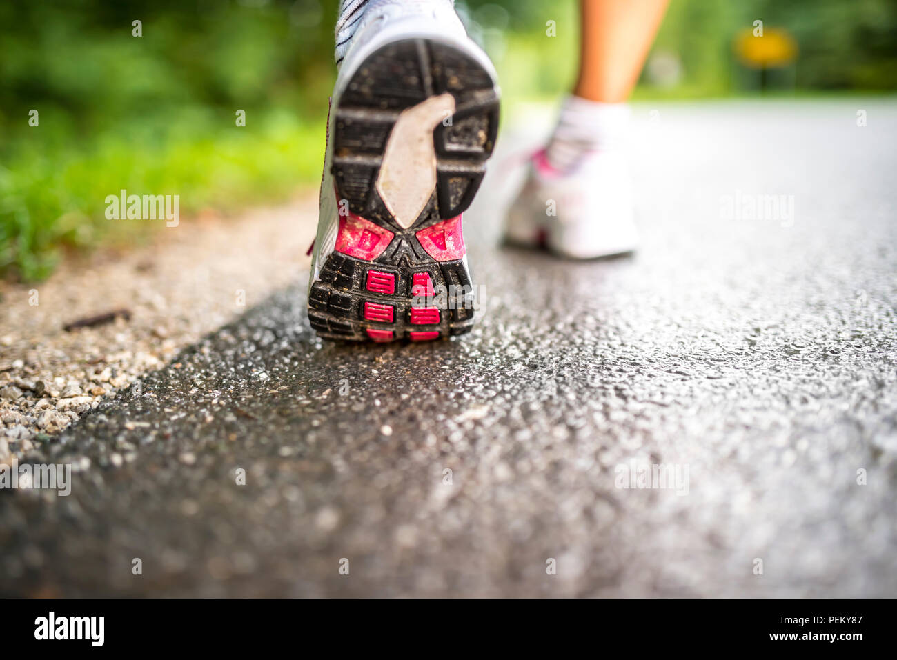 Woman running on wet road hi-res stock photography and images - Alamy