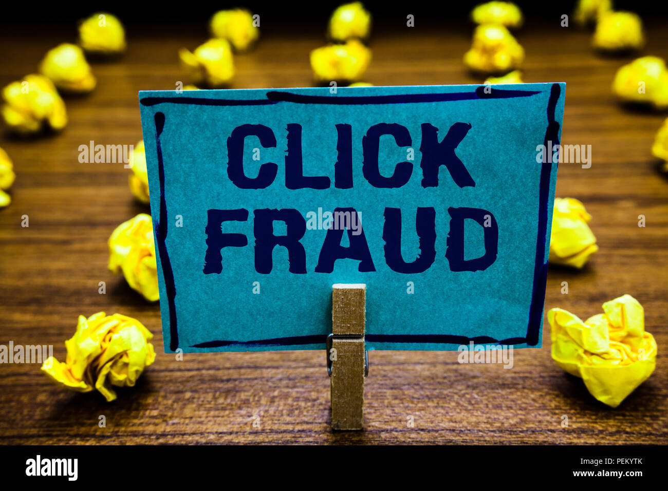 Word writing text Click Fraud. Business concept for practice of repeatedly clicking on advertisement hosted website Clothespin holding blue paper note Stock Photo