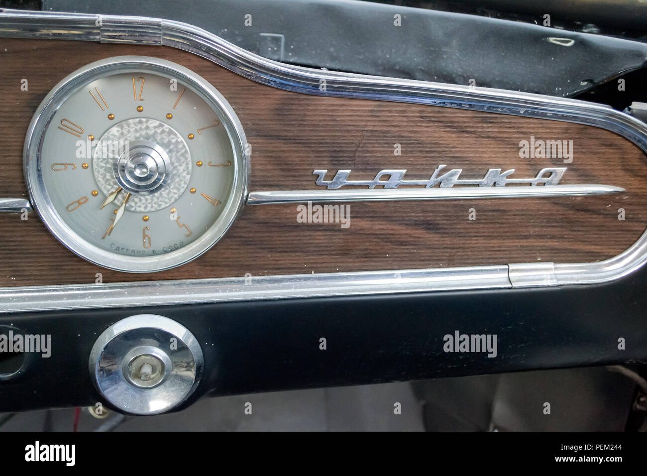 Novosibirsk, Russia - 06.07.2018: Clock  and emblem nameplate on the panel of the old Russian car of the executive class, released in the Soviet Union Stock Photo
