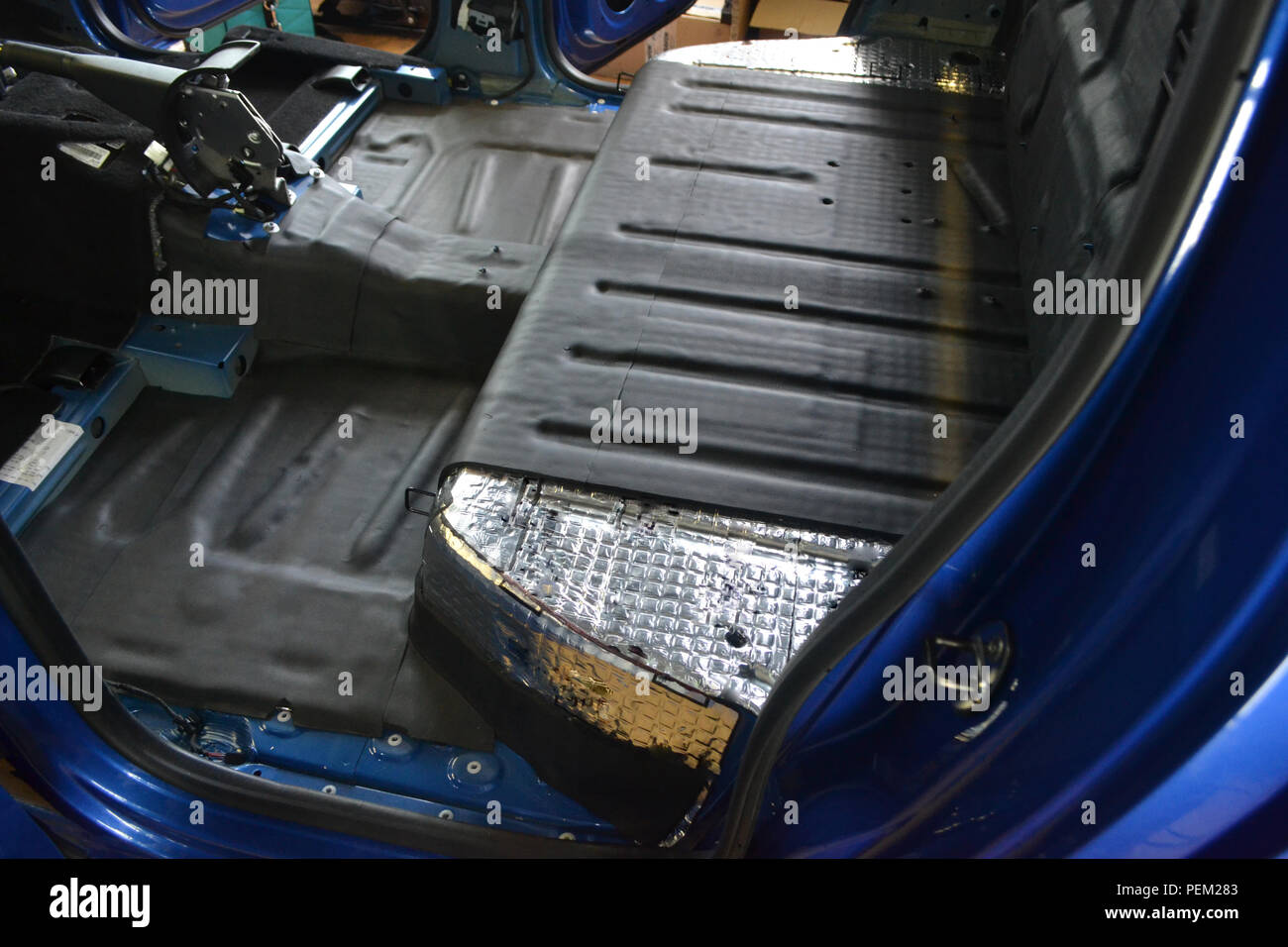 Tuning the car in a pickup truck body with three layers of noise insulation on the floor, under