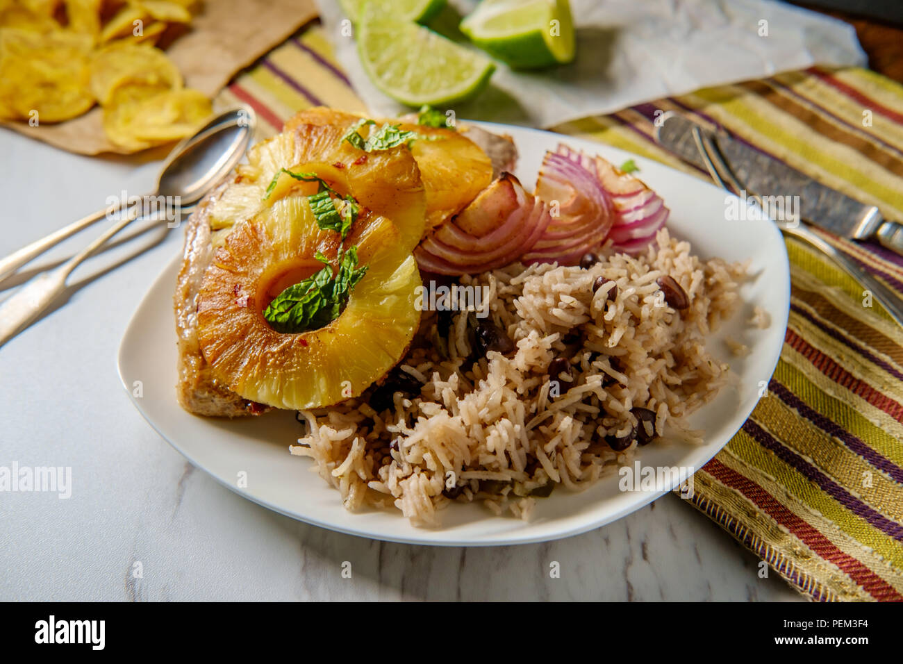 Marinated Cuban pineapple pork chops with traditional black bean rice