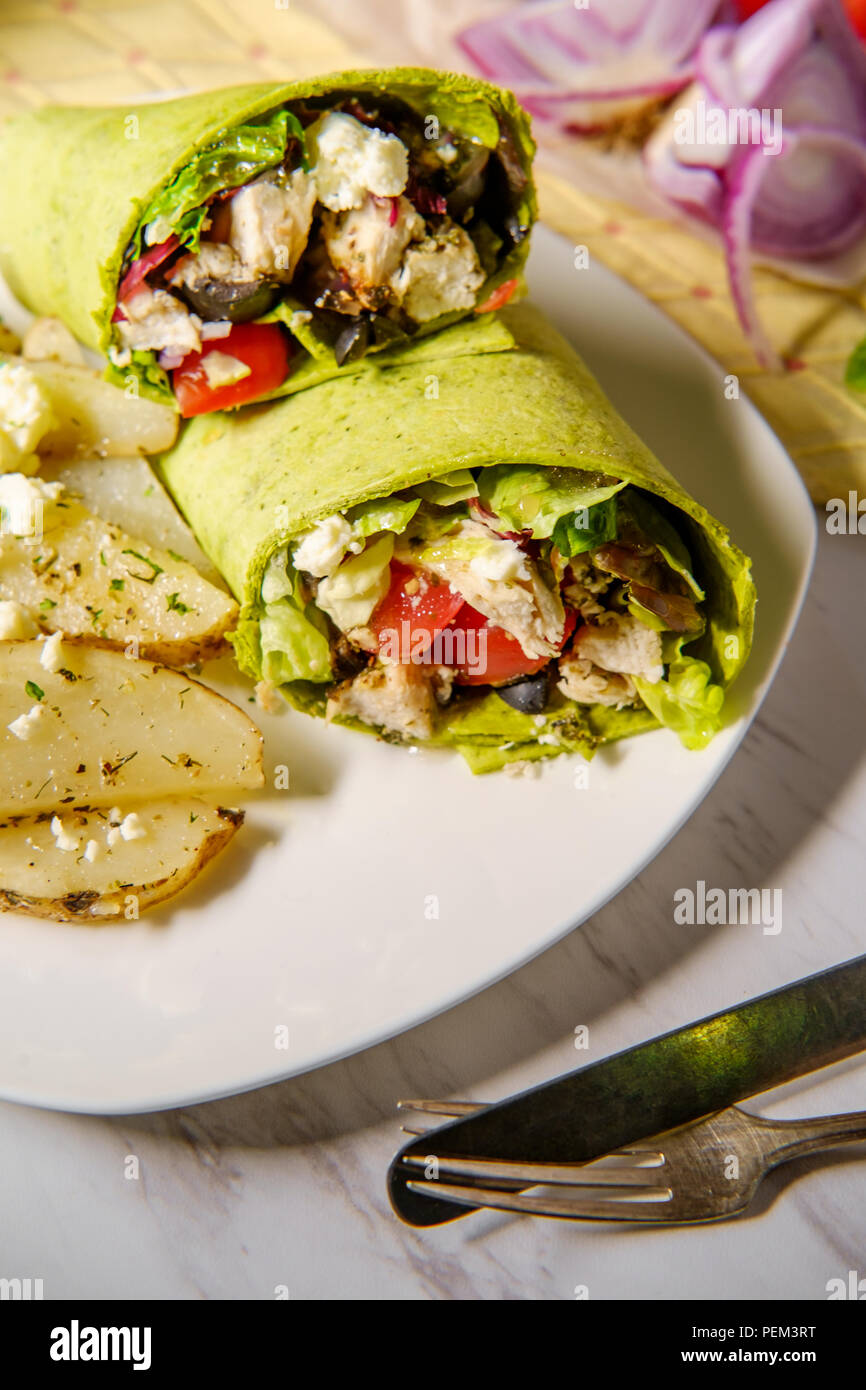 Healthy Greek chicken wrap with herbed potatoes and feta cheese Stock
