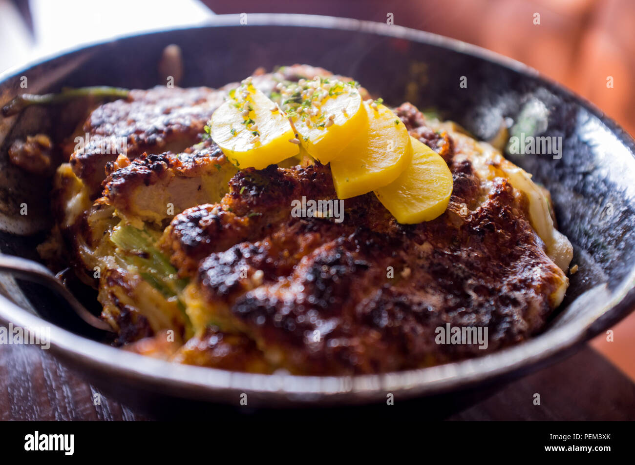 Japanese crispy pork katsudon rice bowl with takuan daikon radish