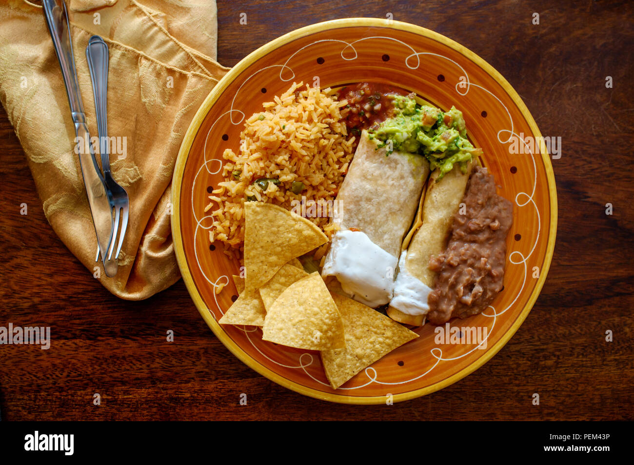Authentic Mexican burrito and taquito dinner with rice and refried