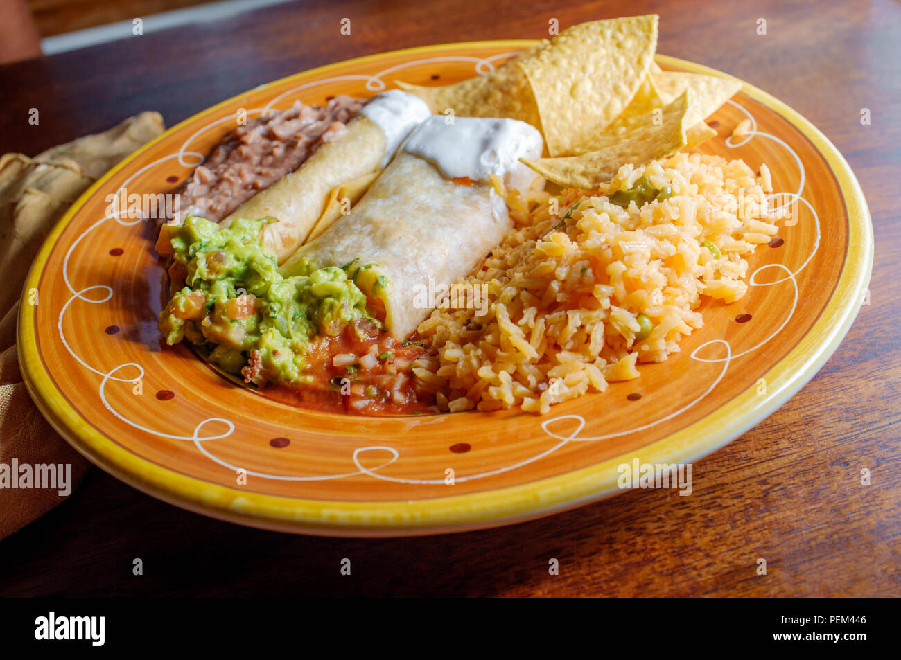 Authentic Mexican burrito and taquito dinner with rice and refried