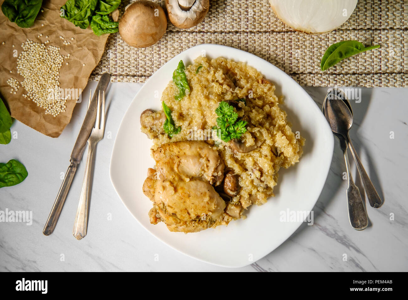 Savory chicken thighs with mushroom quinoa and spinach Stock Photo - Alamy