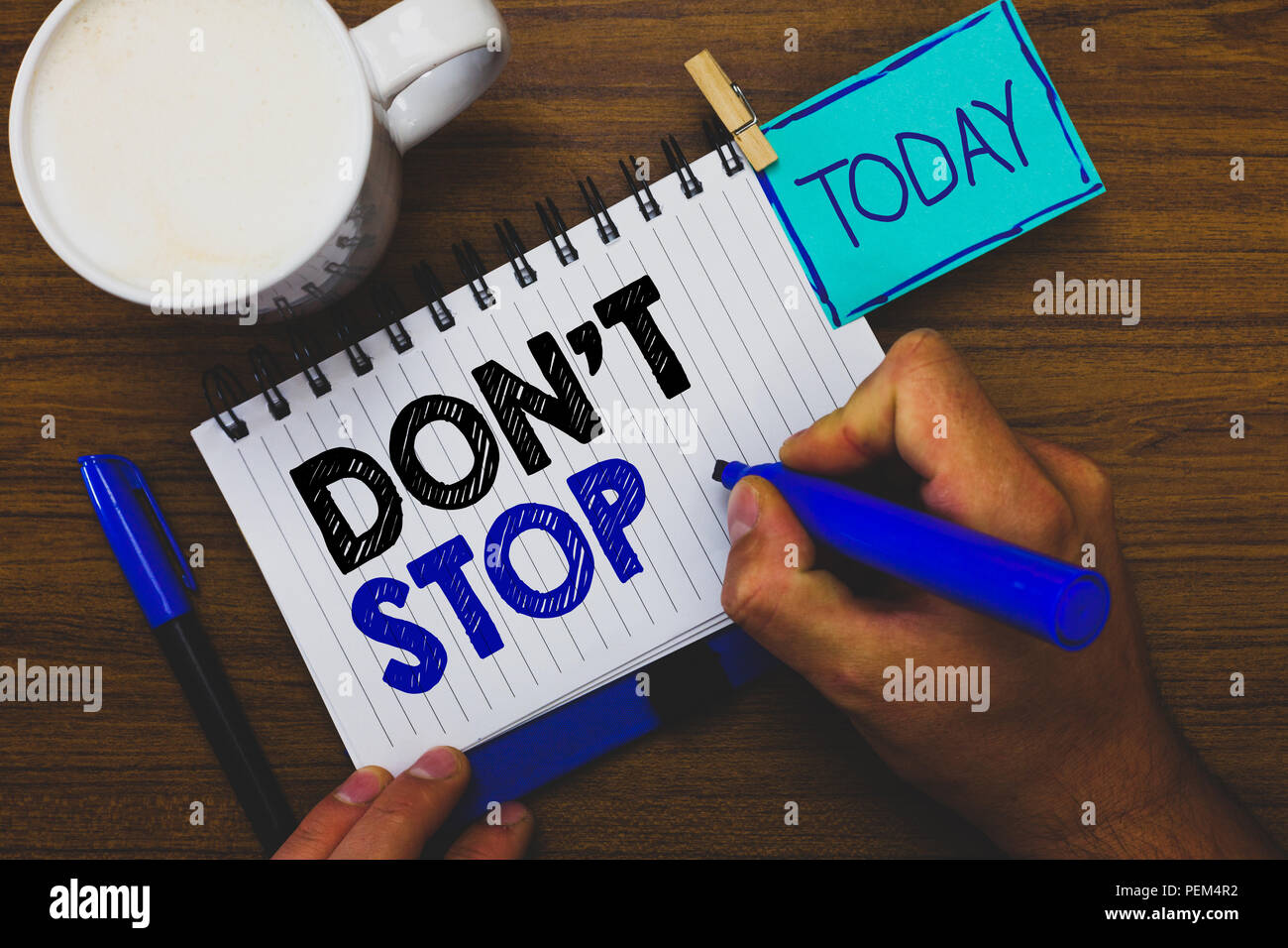 Word writing text Don t not Stop. Business concept for Continue what had been doing without rendering a delay Man holding marker notebook clothespin r Stock Photo