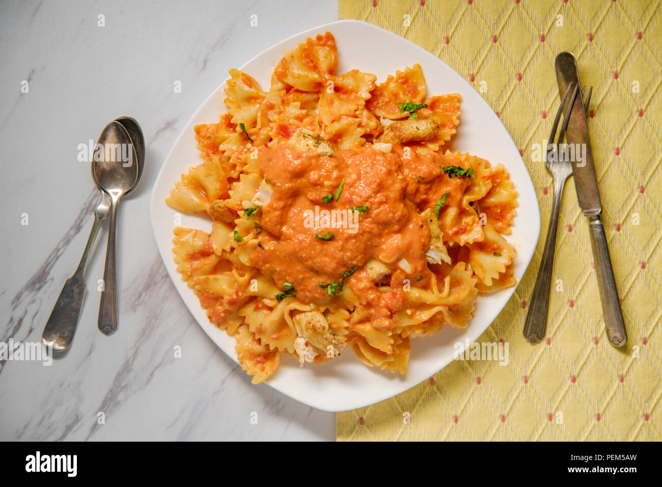 Farfalle bow tie pasta in creamy vodka tomato sauce with grilled