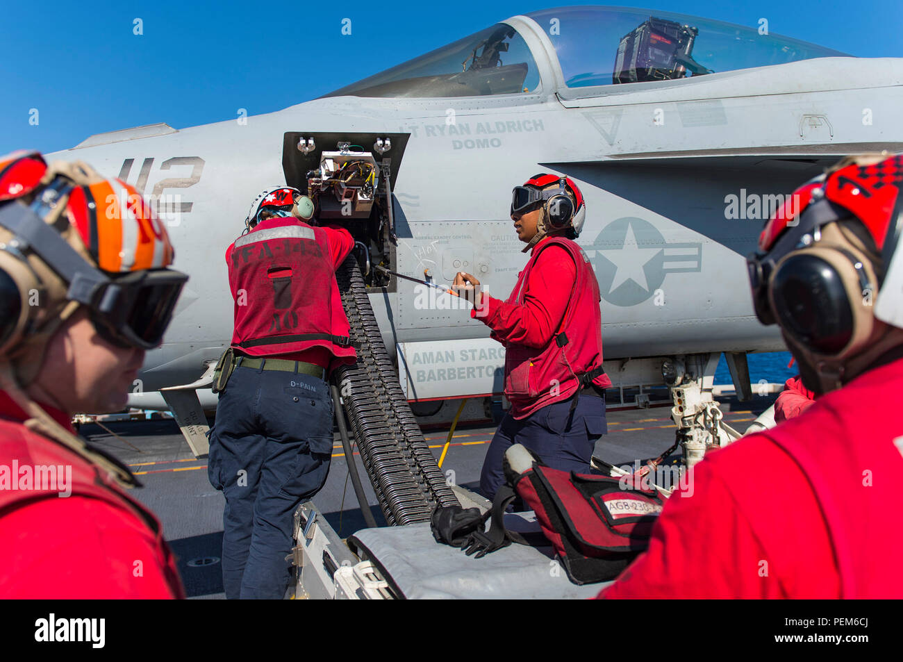 151215-N-NX690-229   RED SEA (Dec. 15, 2015) Aviation Ordnancemen assigned to the “Pukin’ Dogs” of Strike Fighter Squadron (VFA) 143 unload 20 mm rounds from an F/A-18E Super Hornet on the flight deck of aircraft carrier USS Harry S. Truman (CVN 75). Harry S. Truman Carrier Strike Group is deployed in support of maritime security operations and theater security cooperation efforts in the U.S. 5th Fleet area of operation.(U.S. Navy photo by Mass Communication Specialist 3rd Class J. M. Tolbert/Released) Stock Photo