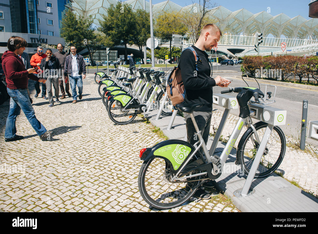 Portugal, Lisbon 29 april 2018: man or tourist rents bicycle or city alternative ecological transport using the mobile app on your phone Stock Photo