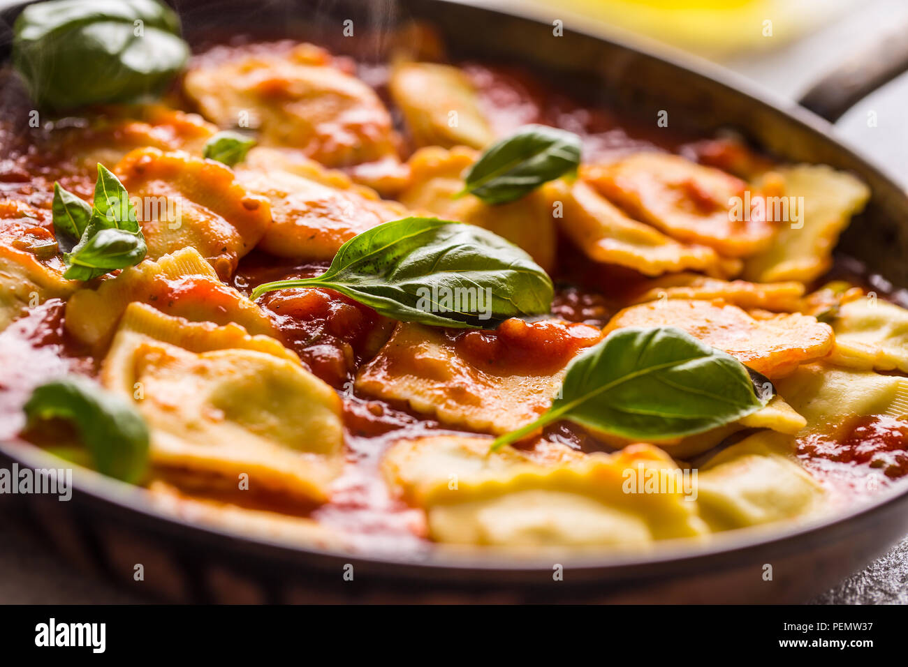 Italian or mediterranean food pasta ravioli of tomato sauce and basil. Stock Photo