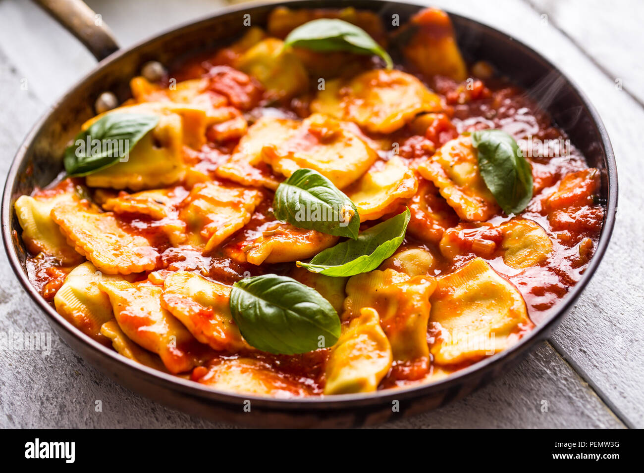 Italian or mediterranean food pasta ravioli of tomato sauce and basil. Stock Photo