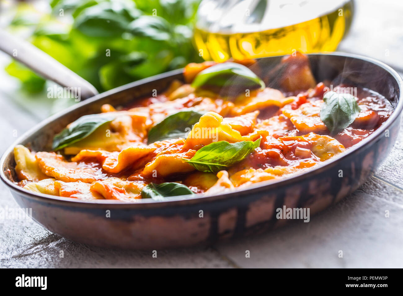 Italian or mediterranean food pasta ravioli of tomato sauce and basil. Stock Photo