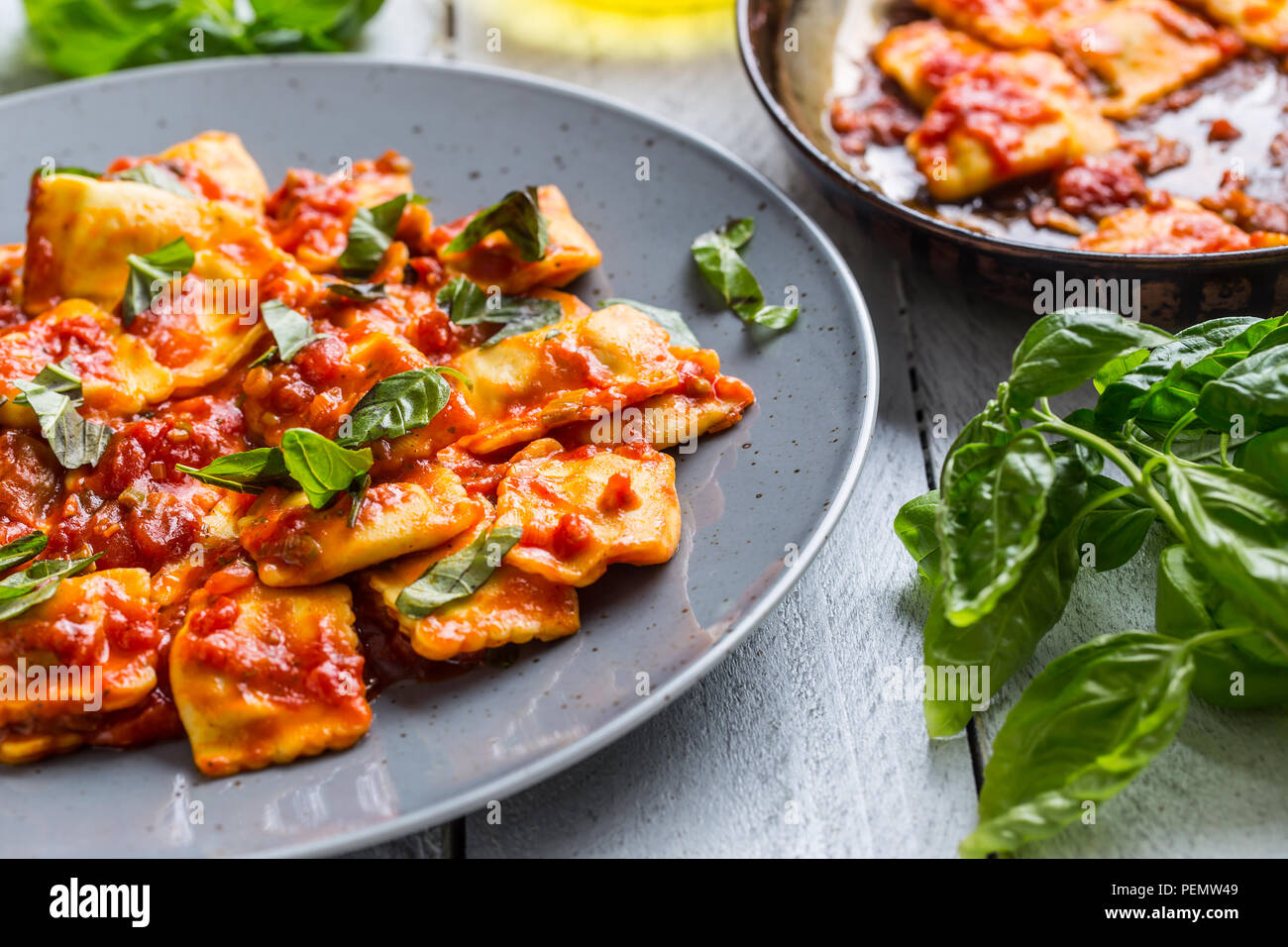 Italian or mediterranean food pasta ravioli of tomato sauce and basil. Stock Photo