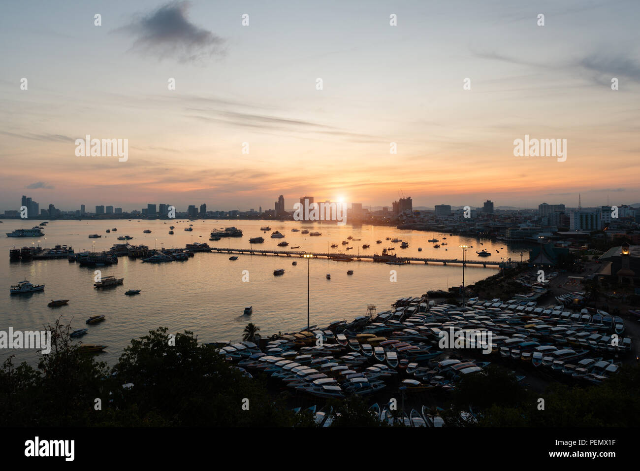 Pier and skyscrapers in twilight time in Pattaya,Thailand. Pattaya city is famous about sea sport and night life entertainment. Stock Photo