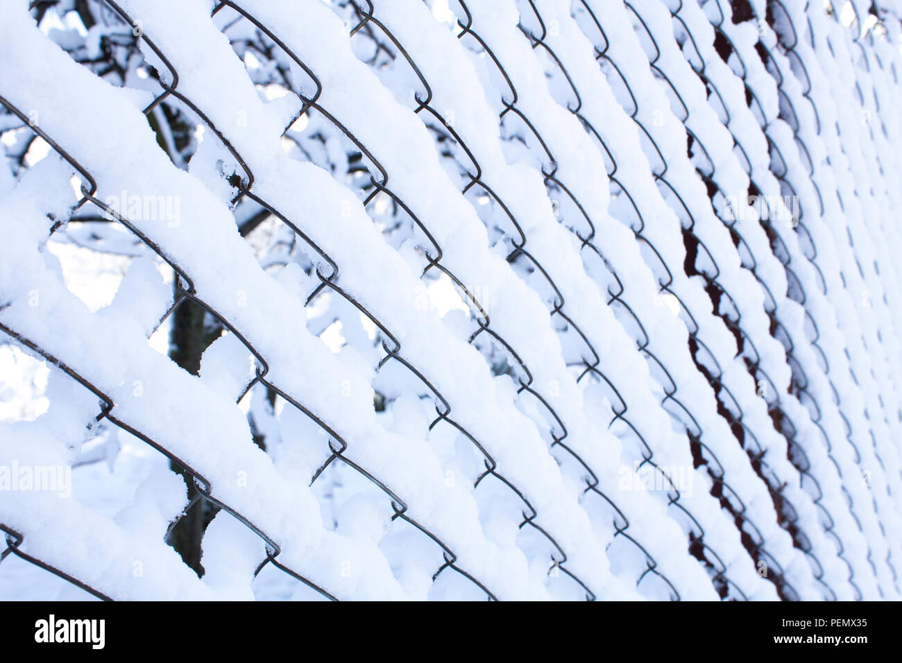 Iron fence in the snow. Lattice fence covered with snow Stock Photo - Alamy