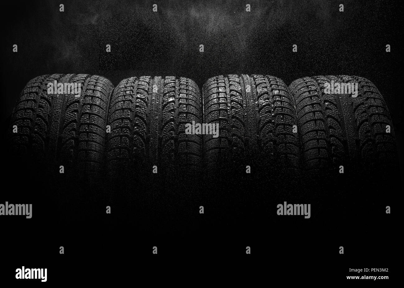 Tires with water drops over black background Stock Photo