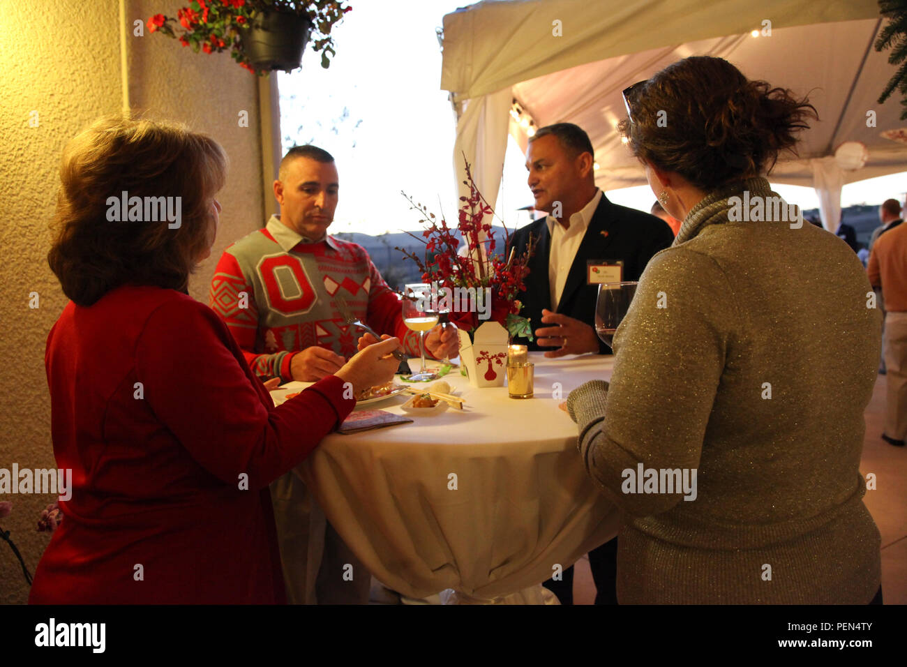 U.S. Marines, Sailors and guests attend a holiday party at the