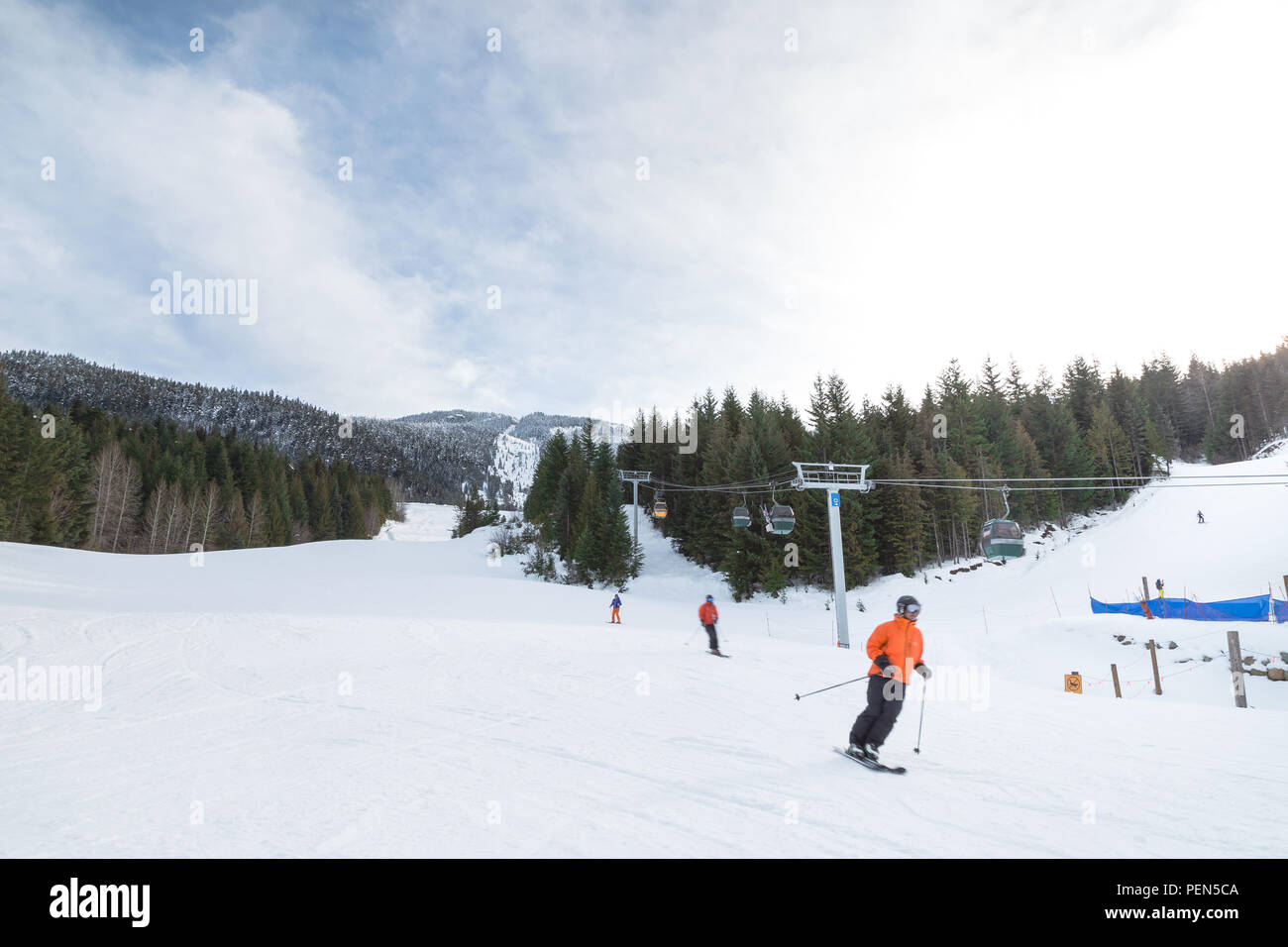 Blurred skiers going downhill on Whistler Mountain. Stock Photo