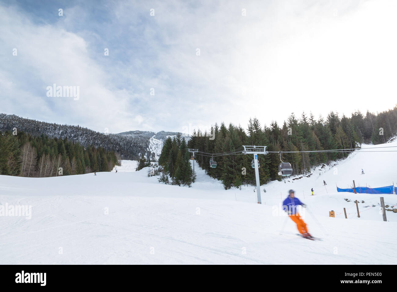 Blurred skiers going downhill on Whistler Mountain. Stock Photo