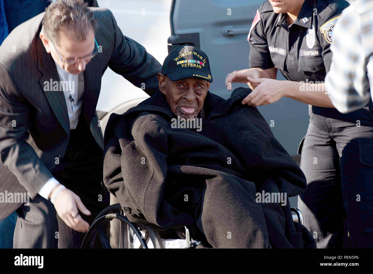Frank Levingston (center), the oldest known World War II veteran, visits the Tomb of the Unknown Soldier at Arlington National Cemetery Dec. 7 as part of the Austin Honor Flight visit to Washington. One of eight children, Levingston is 110 years old. He was born Nov. 13, 1905, in North Carolina and served in the Army as a private. He fought in the Naples-Foggia Campaign in Italy. (Photo by Spc. Brandon C. Dyer) Stock Photo