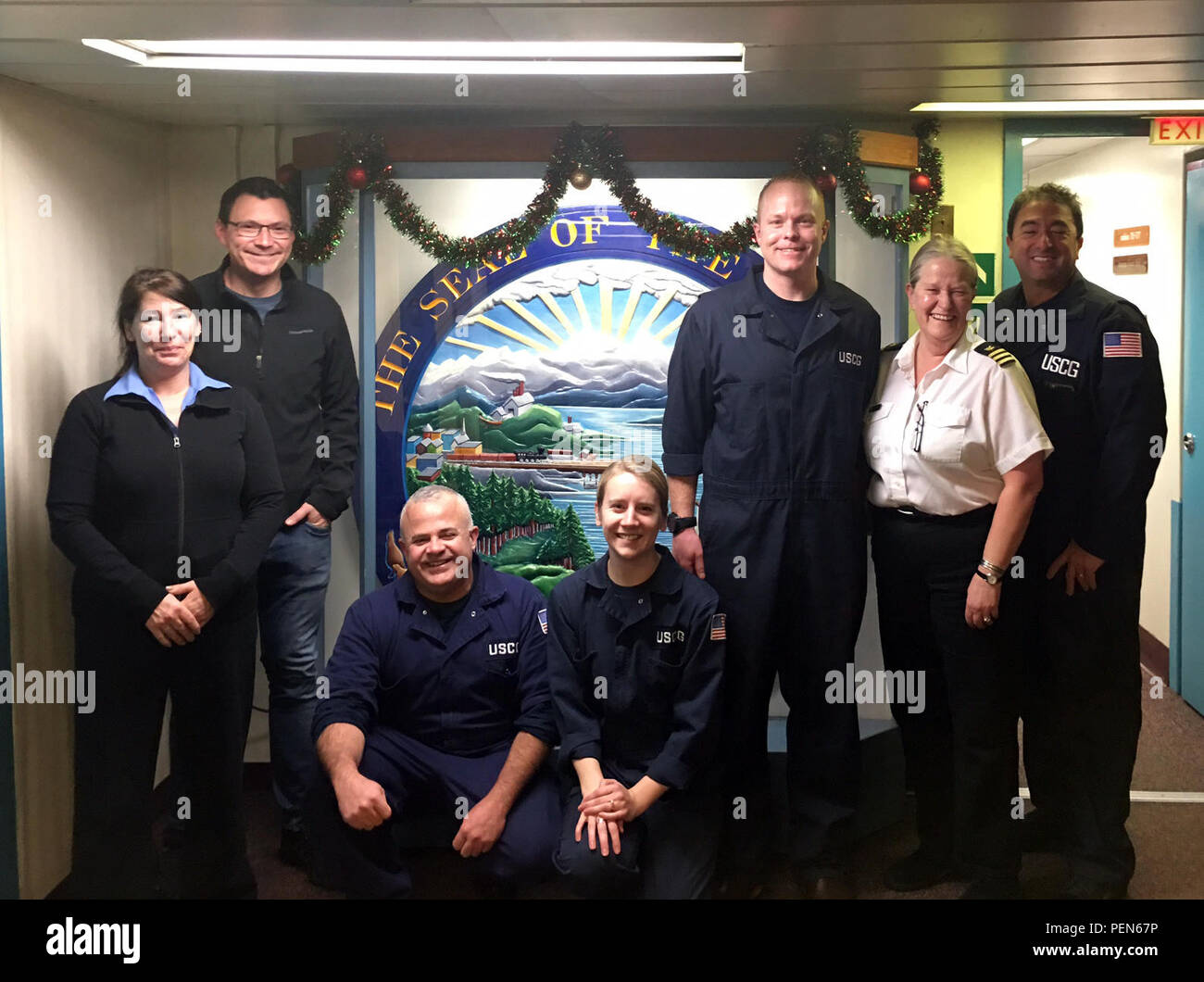 Lt. Ryan Butler, Lt. j.g. Katharine Martorelli, Chief Warrant Officer Israel Nieves and Chief Warrant Officer Martin Donohue from Sector Juneau, Alaska, along with vessel Master Captain Josh McGrath and two other crewmembers, pose for a photo during a ship ride event Dec. 14, 2015.  The event marked the first mutual training agreement between the Coast Guard and Alaska Marine Highway System. (U.S. Coast Guard photo) Stock Photo