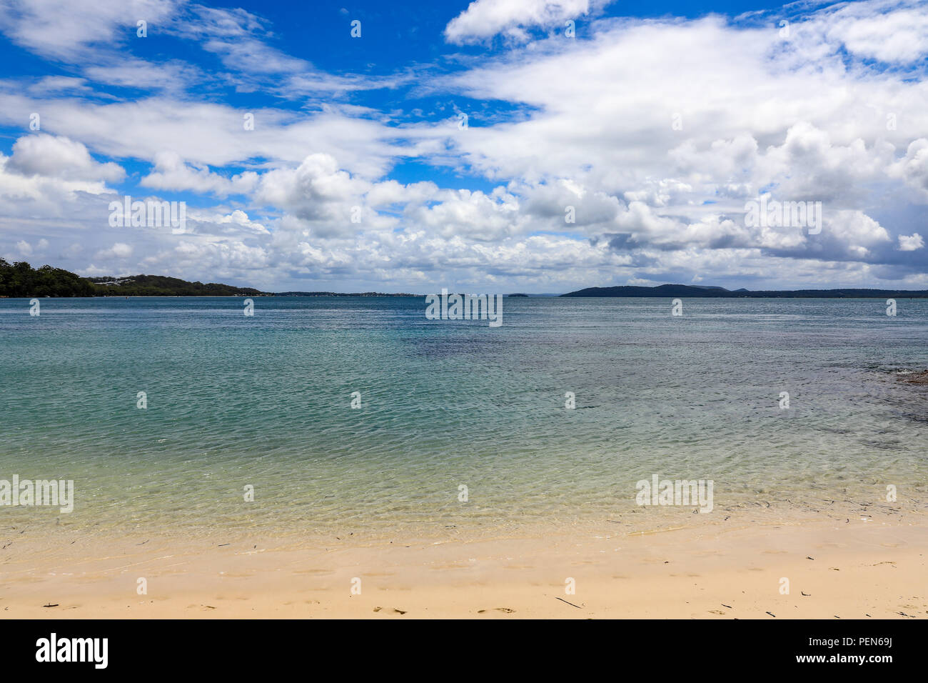 Scenic view of tranquil beach and cloudy blue sky Stock Photo