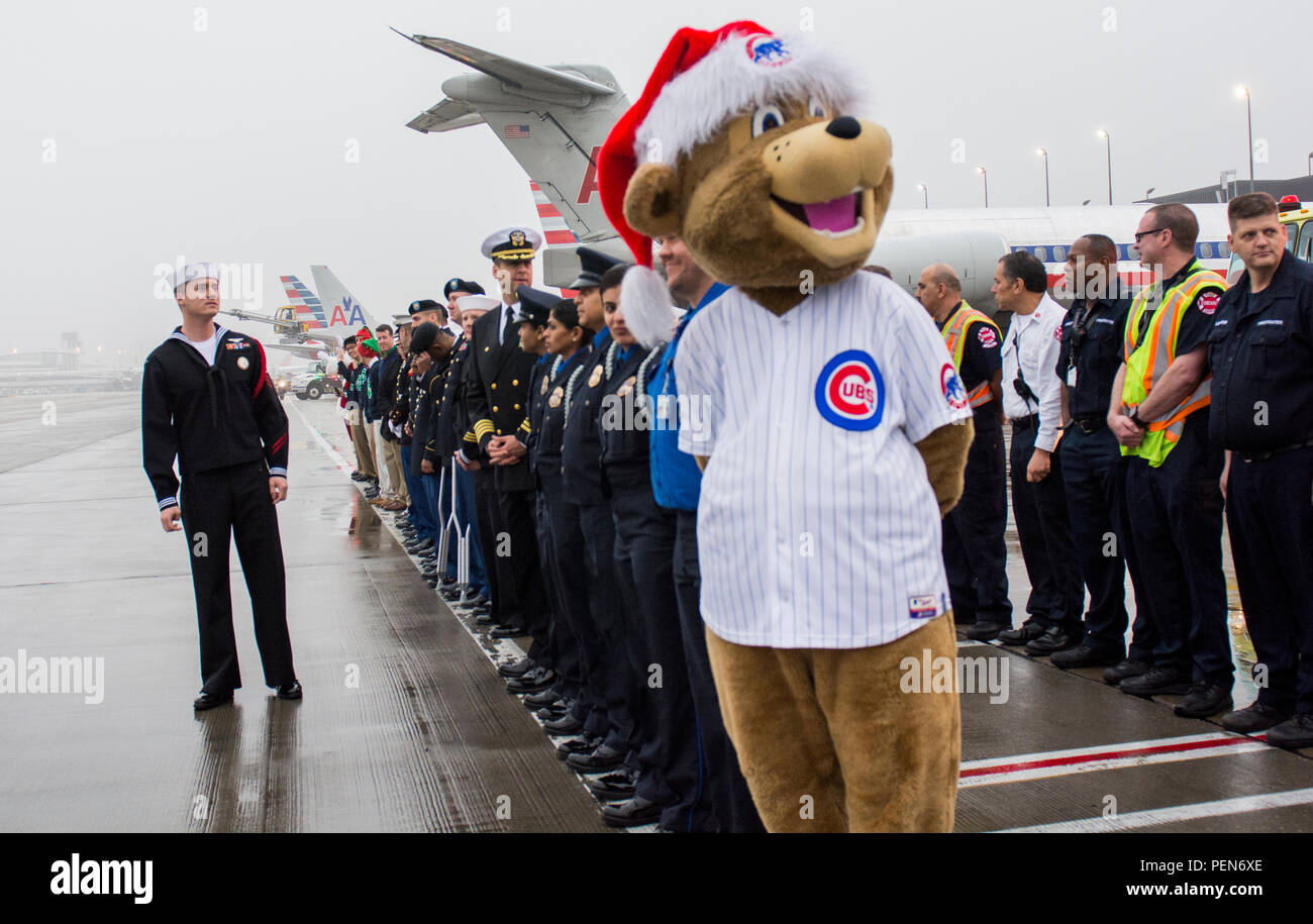 Clark Cub of the Chicago Cubs and  members of the Army Reserve, Navy, Marine Corps, TSA, police force and fire department from the greater Chicago area had come to send off the families participating in the Snowball Express, minus the actual snow, on Dec. 12. The program is sponsored by American Airlines, coordinating flights from 84 cities via nearly 60 chartered and commercial flights. The Snowball Express is a nonprofit organization established in 2006, providing an all-expenses-paid trip to families across the United States with a mission of bringing hope and new memories to the children o Stock Photo