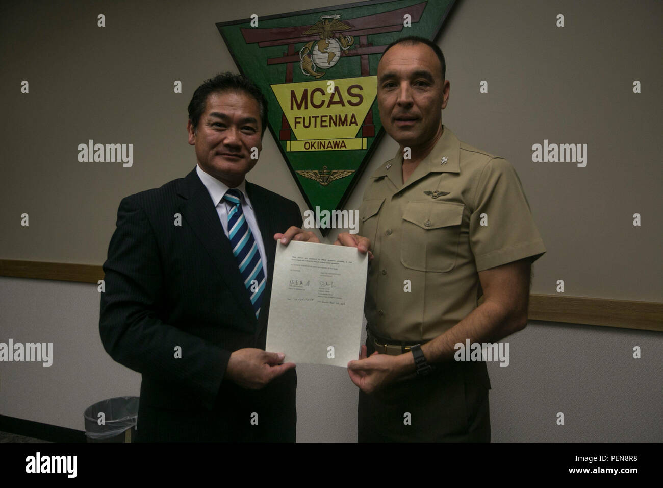 Col. Peter Lee and Ginowan Mayor Atsuchi Sakima pose for a photog