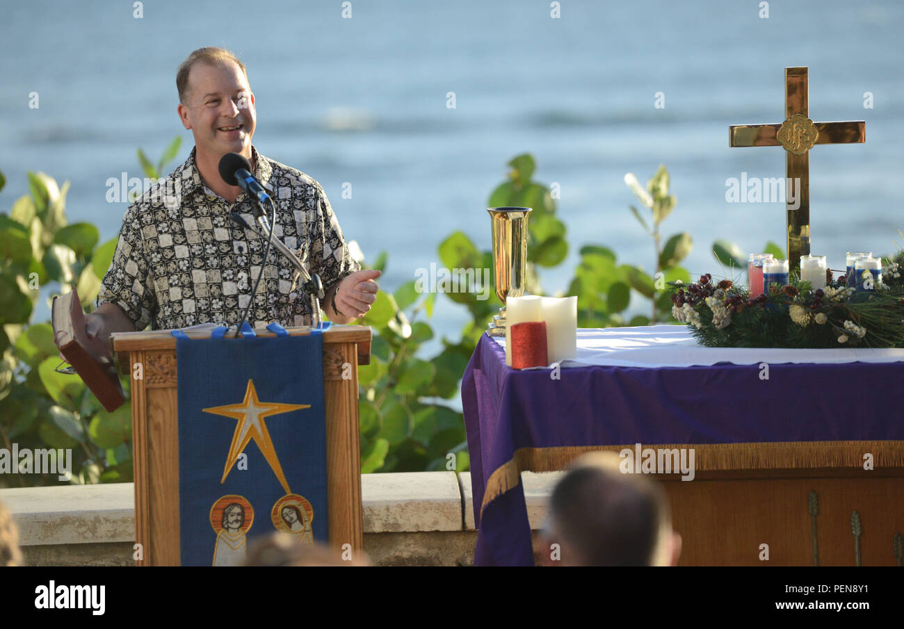 Cmdr. Brian Haley, a chaplain for the Coast Guard 14th District, conducts a Christmas Eve service for several crew members and their families at the Diamond Head Lighthouse, Dec. 24, 2015. The chaplain corps consists of ordained clergy who are commissioned naval officers and whose principal purpose is to promote the spiritual, religious, moral, and personal well-being of the members of the Coast Guard, Navy and Marine Corps. (U.S. Coast Guard photo by Petty Officer 2nd Class Tara Molle/Released) Stock Photo