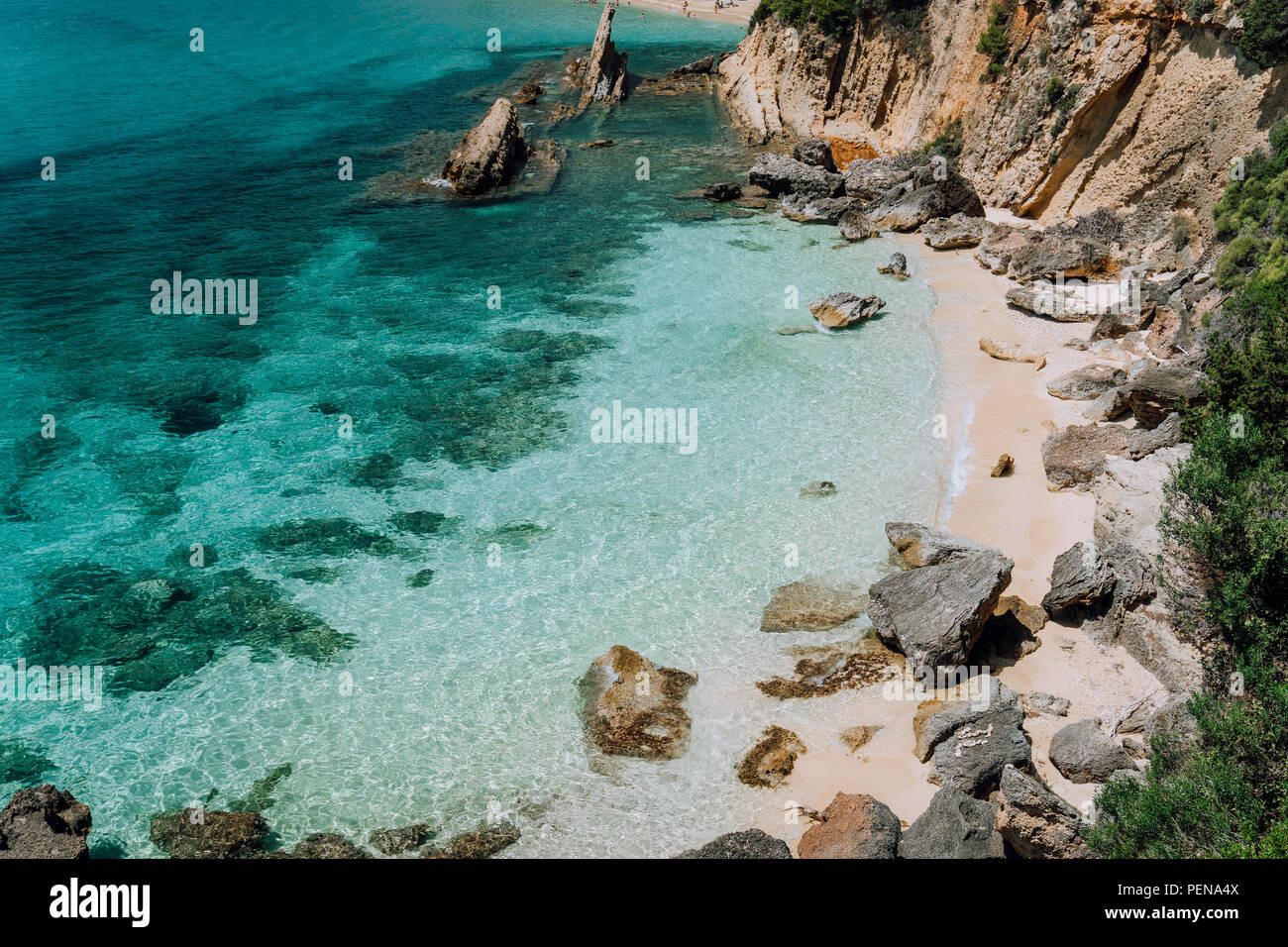 Hidden empty beach with pure clear turquoise sea water near white rock cliffs located in famous beach of Platys and Makrys gialos, Argostoli, Cefalonia island, Ionian, Greece Stock Photo