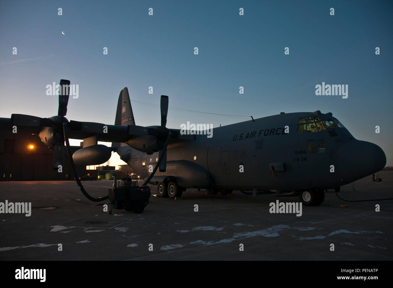 C-130H Hercules sit on a cold flightline as heaters prepare the turbo prop engines for the day at the 179th Airlift Wing, Mansfield, Ohio, Jan. 6, 2015. The Ohio Air National Guard unit is always on mission to respond with highly qualified citizen-airmen to execute Federal, State and community missions. (U.S. Air National Guard photo by Tech. Sgt. Joe HarwoodReleased) Stock Photo