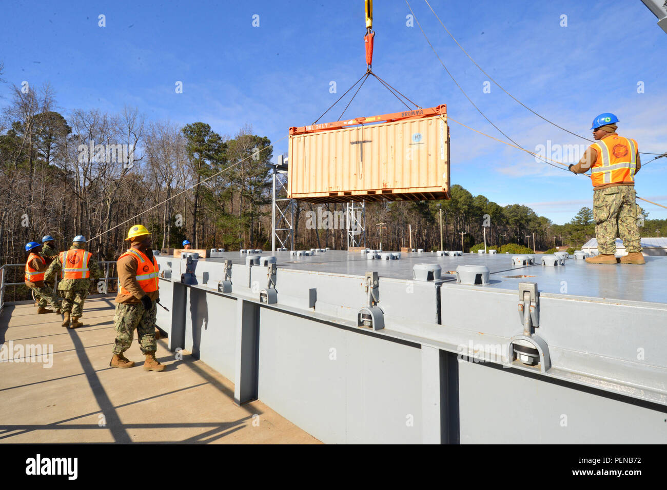 Sailors from Navy Cargo Handling Battalion 1 lower shipping containers ...