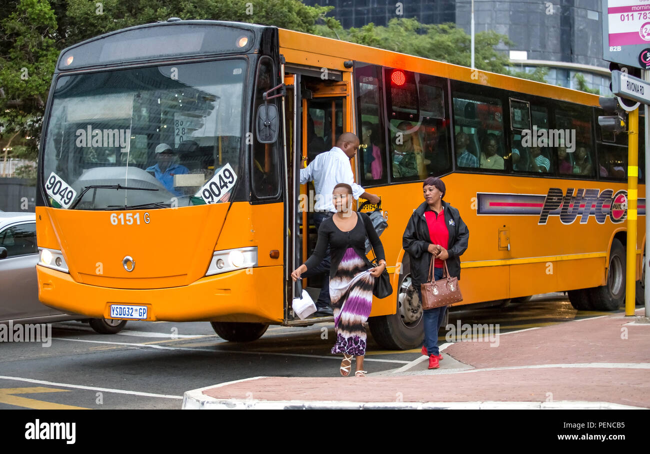 Johannesburg, South Africa - 15 February, 2018: Commuters climbing out of bus in city centre. Stock Photo