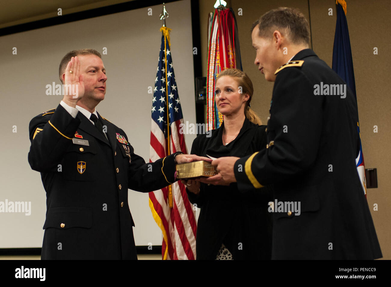 Command Sgt. Maj. James P. Wills takes the oath of office as his wife ...