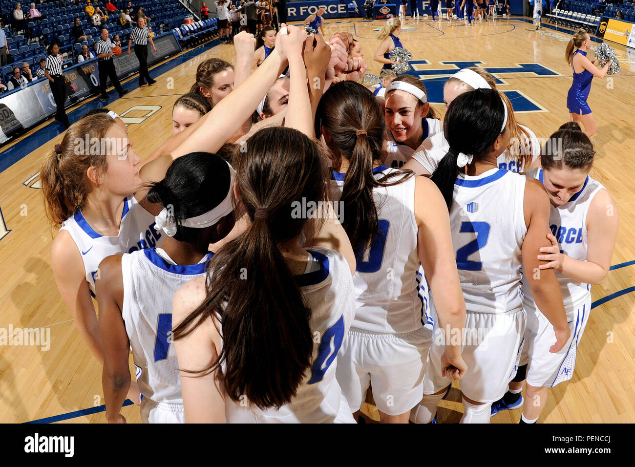 The U.S. Air Force Academy women's basketball team huddles up before tipoff against The Cowgirls of Wyoming at Clune Arena in Colorado Springs, Colo., Jan. 7, 2016. The Falcons started off strong, but fell to Wyoming 67-45 in this Mountain West Conference contest.  (Air Force photo/Jason Gutierrez/released) Stock Photo