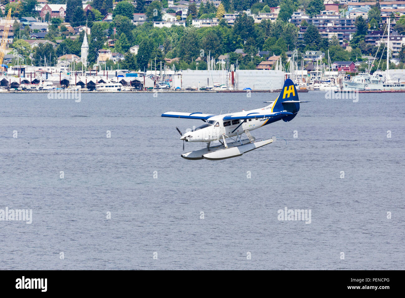 Seaplane C-GUTW a De Havilland DHC-3 Turbo Otter, coming in to land after taking tourists for a pleasure flight from the harbour at Vancouver, British Stock Photo