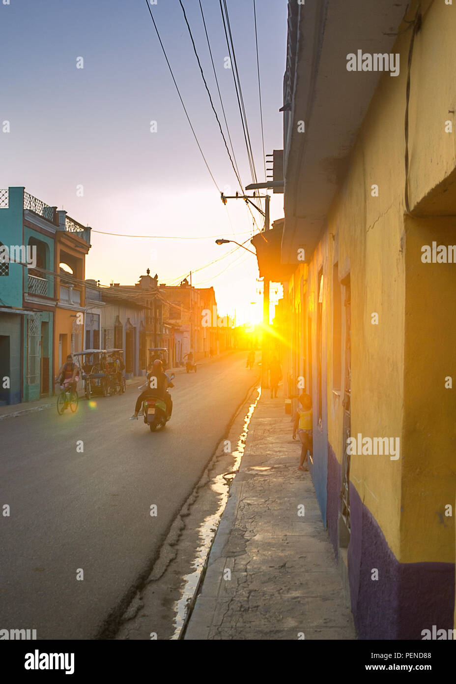A street of an ancient colonial town in the bright rays of the setting sun. Stock Photo