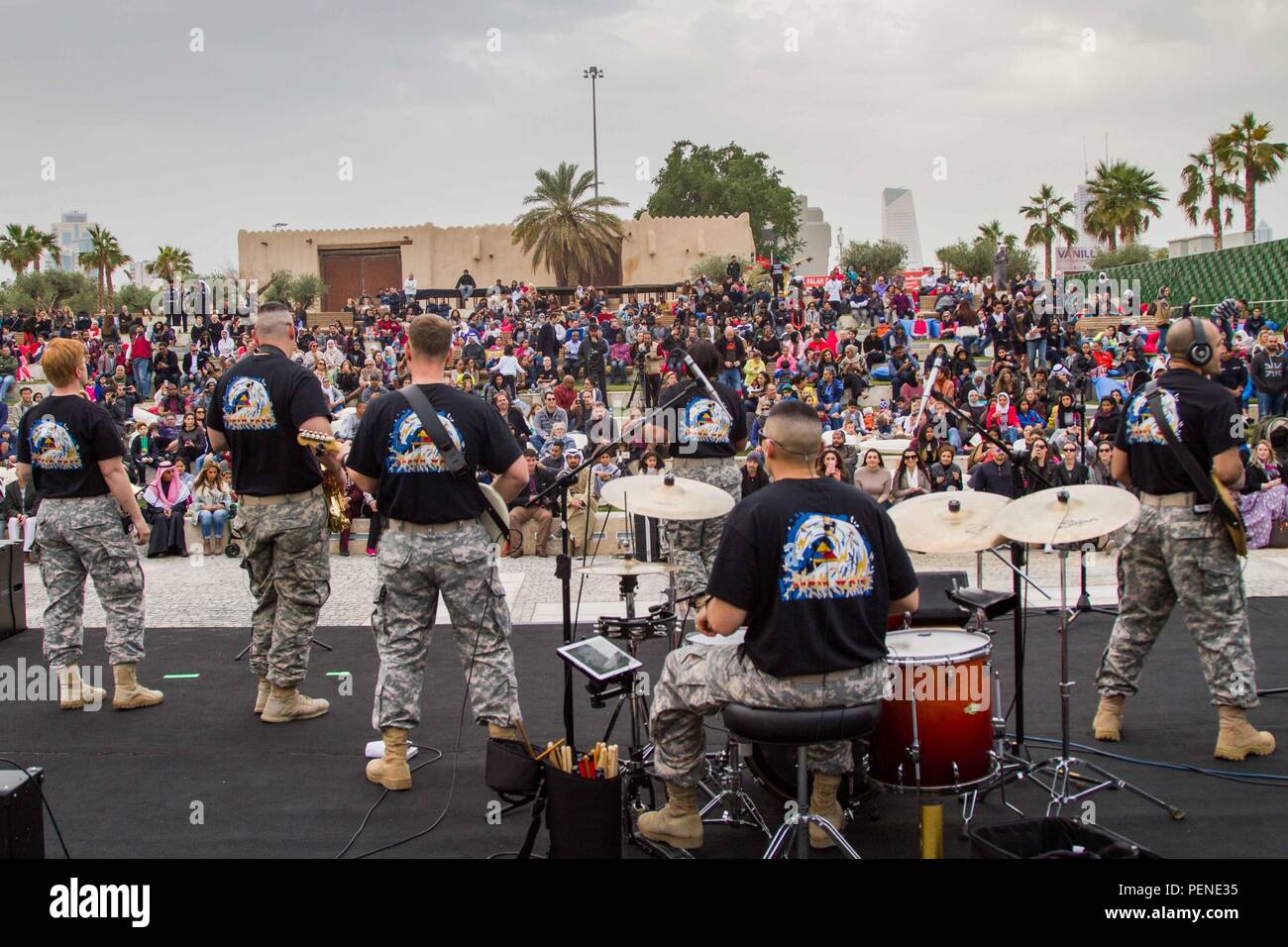 Members of Shockwave, the 1st Armored Division Rock Band, perform before a standing room only crowd at the United Through Music cultural event at Al-Shaheed Park, Kuwait City, Jan. 8. The event was part of the 25th anniversary celebration of Kuwait’s liberation during the Gulf War. (U.S. Army photo by Sgt. David N. Beckstrom, 19th Public Affairs Detachment, U.S. Army Central) Stock Photo
