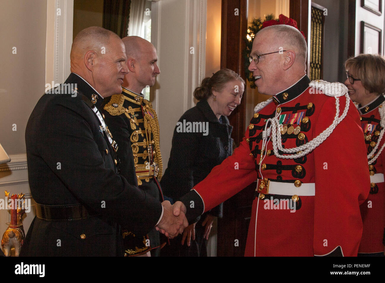 The Commandant of the Marine Corps, Gen. Robert B. Neller, left, greets a member of the U.S. Marine Corps Band during the annual New Year’s Day Serenade at the Home of the Commandants in Washington, D.C., Jan. 1, 2016. The serenade is a tradition that dates back to the 19th century. (U.S. Marine Corps photo by Cpl. Samantha K. Draughon/Released) Stock Photo