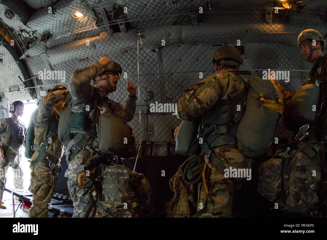 A U.S. Army jump master assigned to Special Operations Command South commands his chalk to "hook