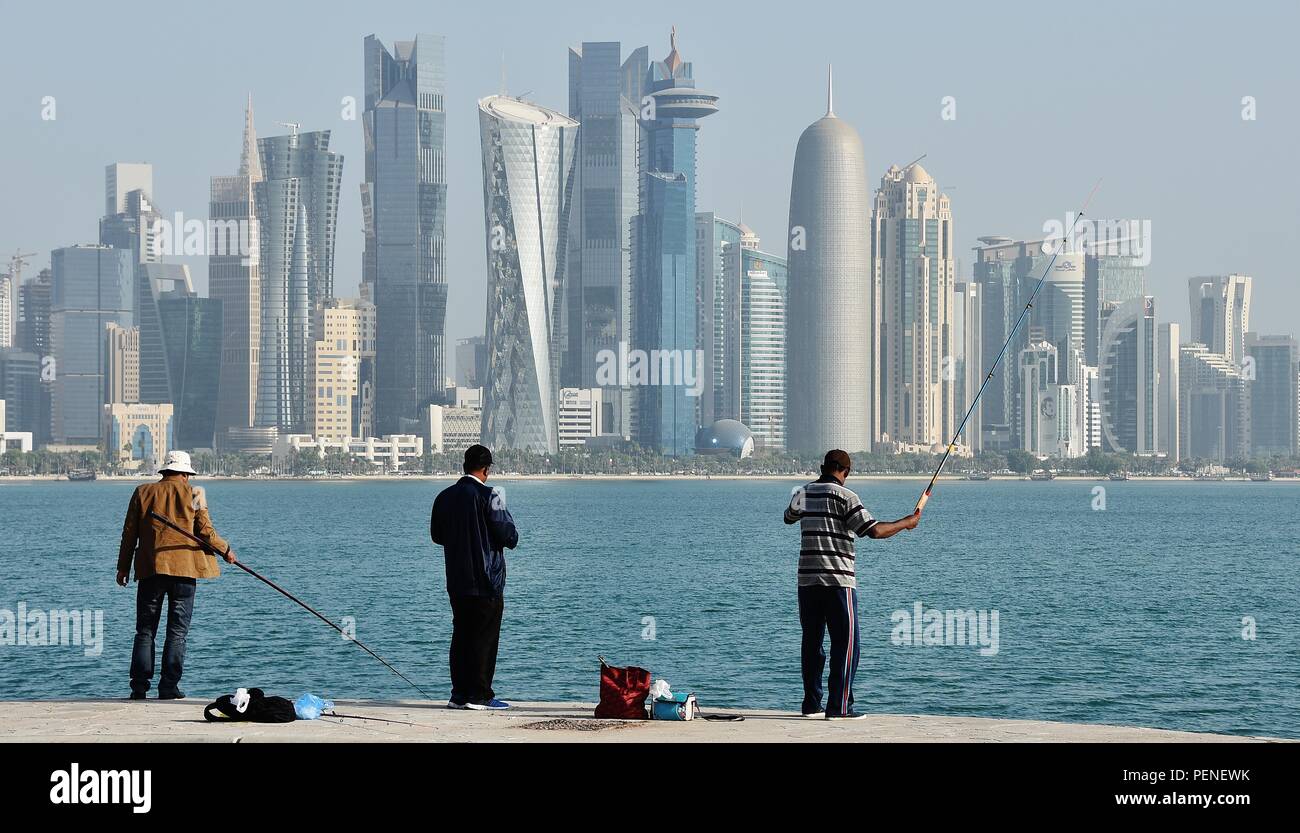 Fishermen fishing against the backdrop of West Bay, Doha, Qatar Stock Photo